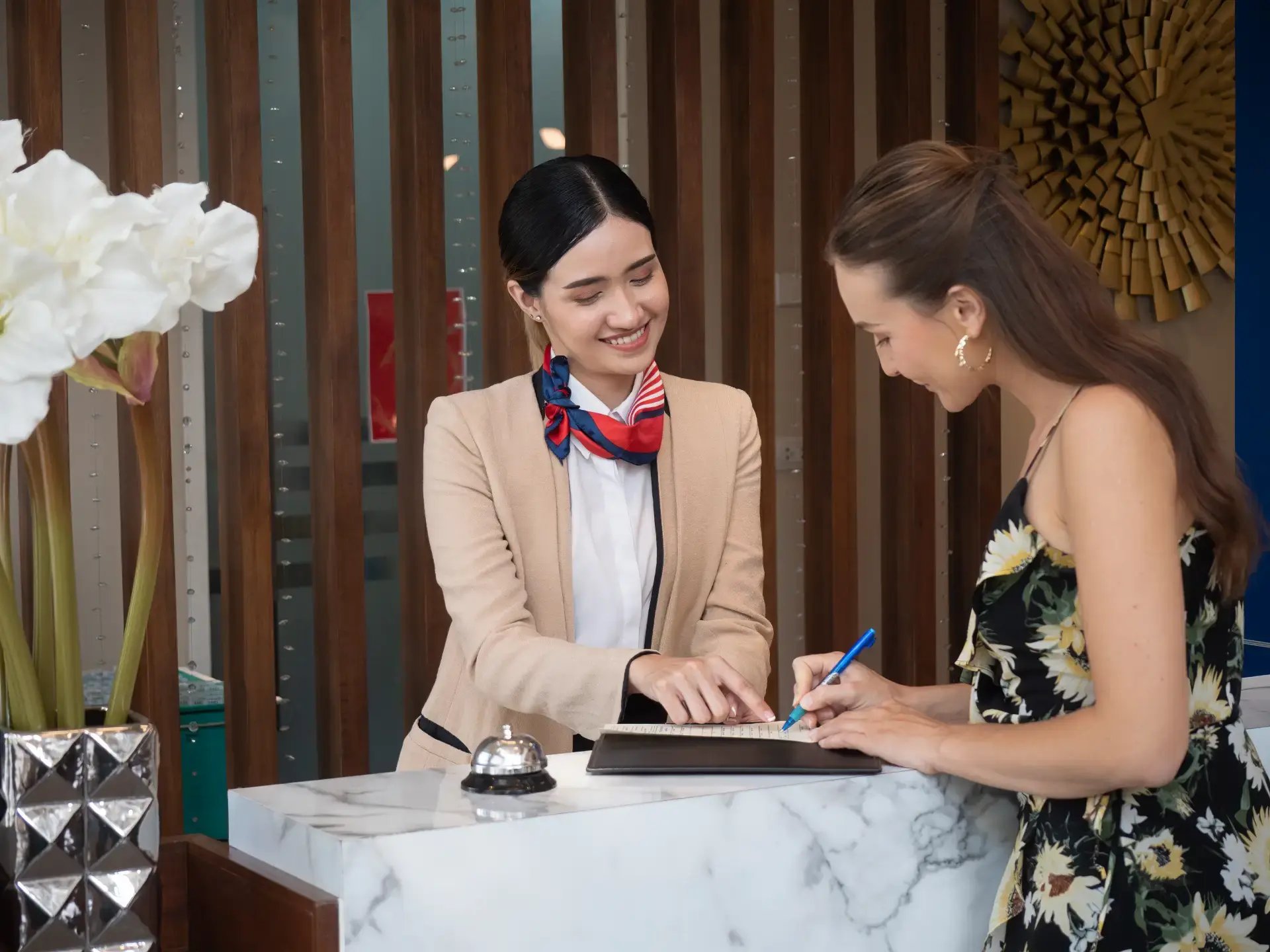 Women signing in at hotel front desk