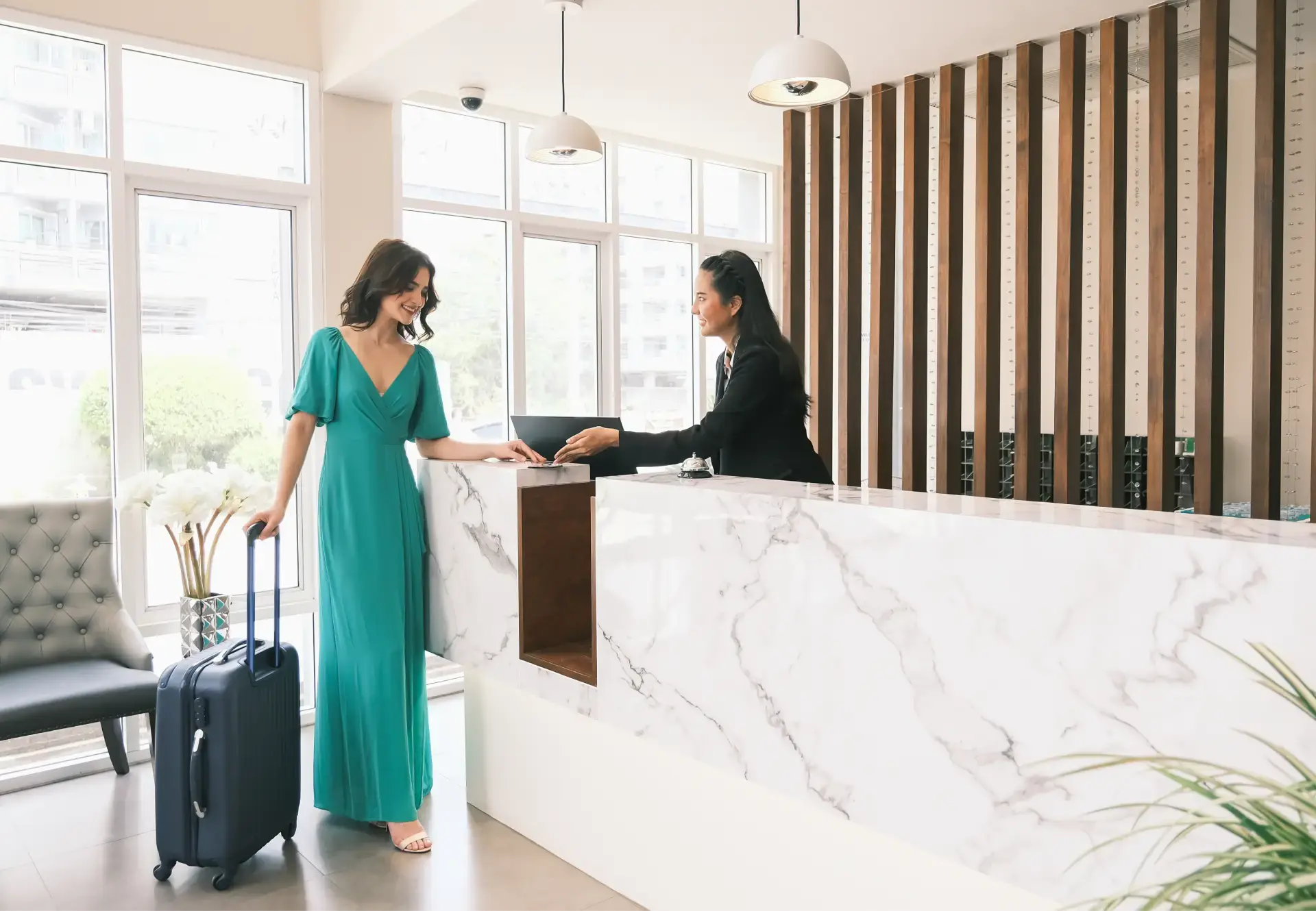 women checking in at hotel front desk